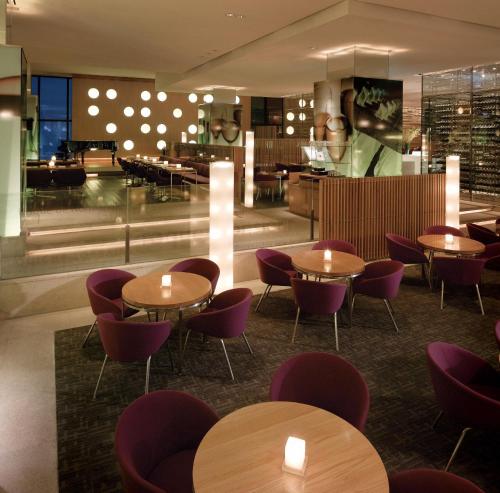 a restaurant with round tables and purple chairs at Grand Hyatt Incheon in Incheon