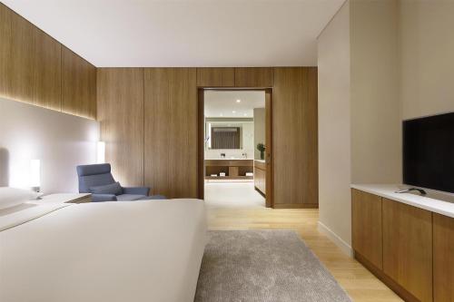 a hotel room with a bed and a television at Grand Hyatt Incheon in Incheon