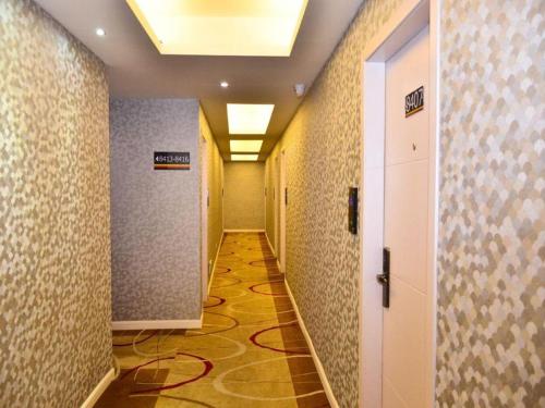a corridor of a hallway with a sign on the wall at Super 8 Hotel Yiwu Binwang in Yiwu