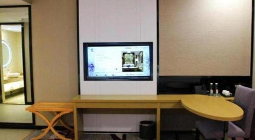a television sitting on top of a table in a room at Lavande Hotels·Qingyuan Jinbiwan in Qingyuan