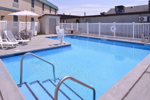 a large blue swimming pool with a white fence at Quality Inn Selinsgrove in Selinsgrove
