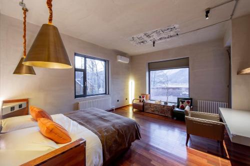 a bedroom with a bed and a living room at Yabuli QuShe Four seasons Private Lakefornt B&B in Xinhua