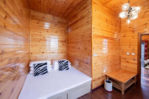a wooden room with a bed in a sauna at Yabuli QuShe Four seasons Private Lakefornt B&B in Xinhua
