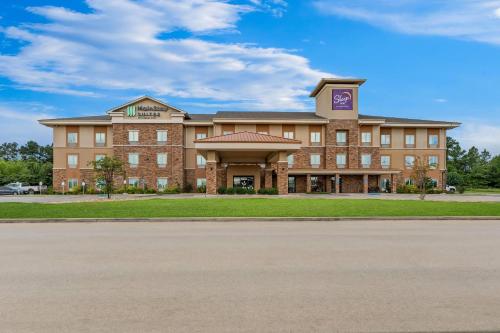 a large brick building with a clock tower at Sleep Inn Lufkin in Lufkin