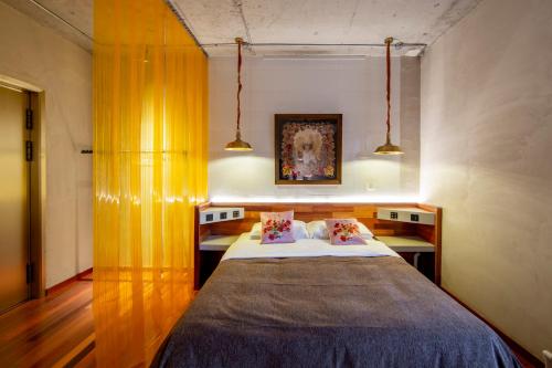 a bedroom with a large bed with two pillows at Yabuli QuShe Four seasons Private Lakefornt B&B in Xinhua