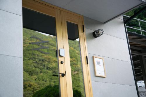 a glass door with a view of a mountain at SEN.RETREAT TAKIJIRI in Tanabe