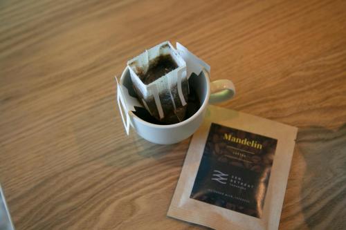a cup of cake and a book on a table at SEN.RETREAT TAKIJIRI in Tanabe