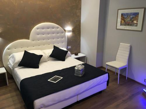 a bedroom with a large bed and a chair at Roma Veneto Relais in Rome