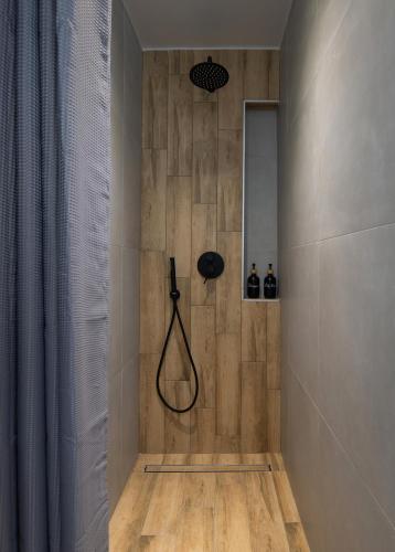 a bathroom with a shower with a black shower head at Bay Leaves Vourvourou in Vourvourou