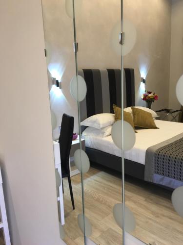 a bedroom with a bed and a mirror at Roma Veneto Relais in Rome