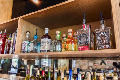 a bunch of bottles of alcohol sitting on a shelf at Cambria Hotel Copper Mountain in Frisco