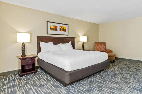 a hotel room with a bed and a chair at Country Inn & Suites by Radisson, Princeton, WV in Princeton