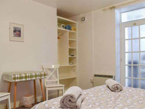 a white bedroom with a bed and a window at Flat 1 Garden View - Ukc4221 in Lowestoft