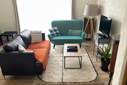 a living room with a couch and a chair at Le 139' in Quimper