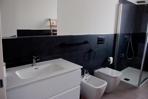 a bathroom with a sink and a toilet at Gioja suite in Quartu SantʼElena