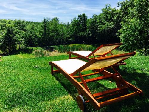 a wooden cart sitting in the grass in a field at Casale San Galgano in Chiusdino