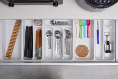 a drawer filled with utensils and other kitchen items at 綯 -NAU- in Yakushima