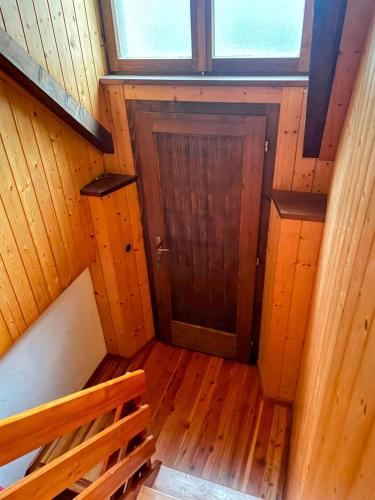 an overhead view of a wooden room with a door at Baita Sostasio in Prato Carnico