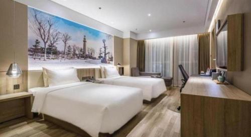 a hotel room with two beds and a painting on the wall at Atour Hotel Weihai Shidao in Dongshan