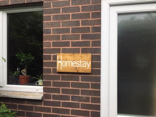 a sign on the side of a brick building at Homestay Norwich in Norwich