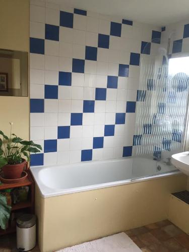 a bathroom with a tub and a sink at Homestay Norwich in Norwich
