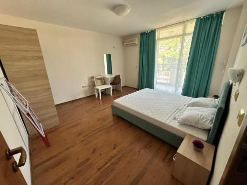 a bedroom with a bed and a large window at PSB Apartments in Midia Resort Aheloy in Aheloy