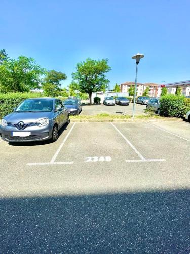 a silver car parked in a parking lot at " Souffle Vert " Wifi - TV - 4 personnes in Muret