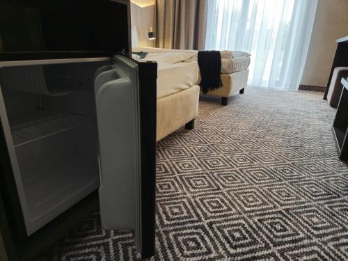 a living room with a couch and a chair at Mikołajki Resort Hotel & Spa Jora Wielka in Mikołajki