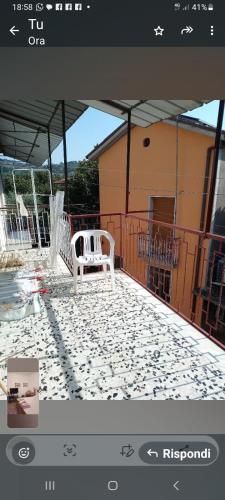 a patio with a white bench on top of a building at Al casale in Capriglia