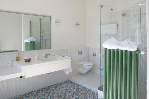 a bathroom with a sink and a toilet and a shower at Gasthof Hirschen in Eglisau