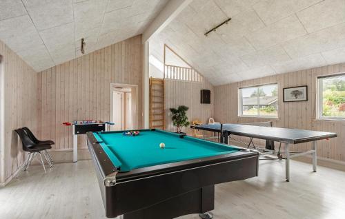 a billiard room with a pool table and a table at Nice Home In Vejby With Sauna in Vejby