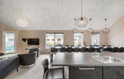 a large dining room with a table and chairs at Nice Home In Vejby With Sauna in Vejby