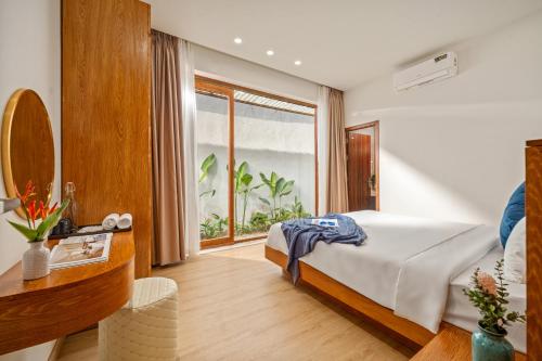 a bedroom with a bed and a large window at Tropical Villa - Near My Khe Beach & City Center by The Key in Da Nang