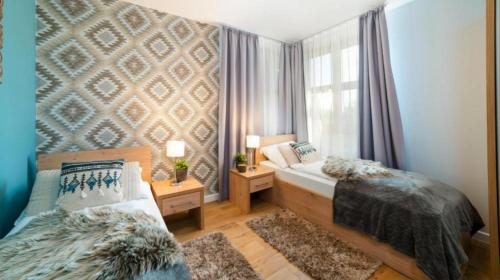 a bedroom with two beds and a window at Wiking in Skorka