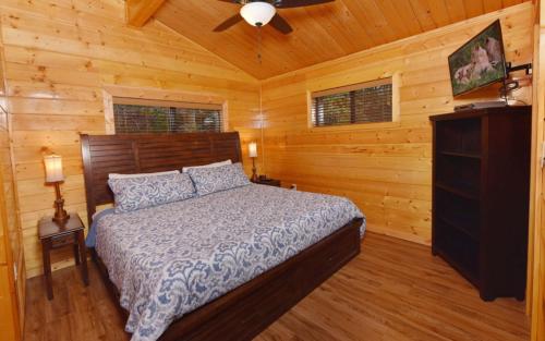 a bedroom with a bed in a log cabin at Bearfoot Lodge in Gatlinburg
