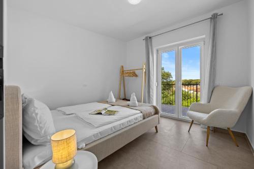 Postel nebo postele na pokoji v ubytování Apartmani Paliska