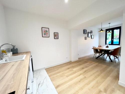 a kitchen and dining room with a wooden floor at Le Design proche de la mer in Le Tréport