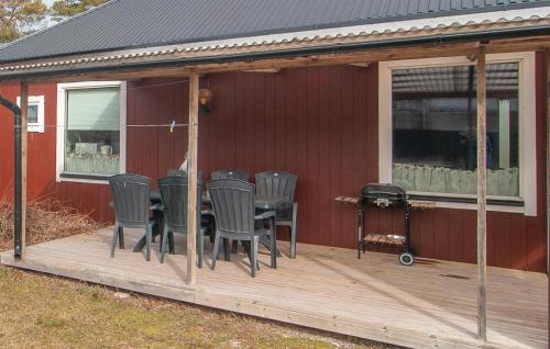 a deck with chairs and a table on a house at Two-Bedroom Holiday Home In Visby in Visby