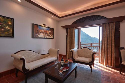 a living room with two chairs and a table at Chandragiri Hills Resort Kathmandu-Luxury in the Clouds in Thānkot