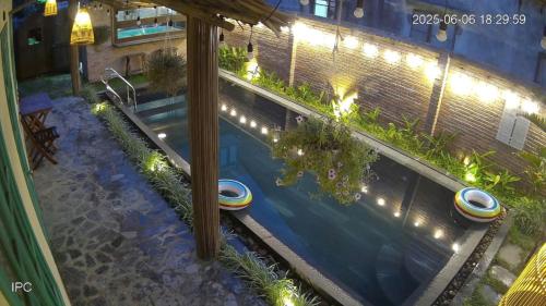 an overhead view of a swimming pool at night with lights at Lamer Coastal Villa in Hoi An