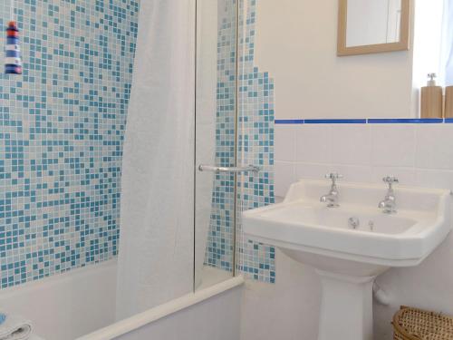a bathroom with a sink and a shower at Preswylfa in Llanddona