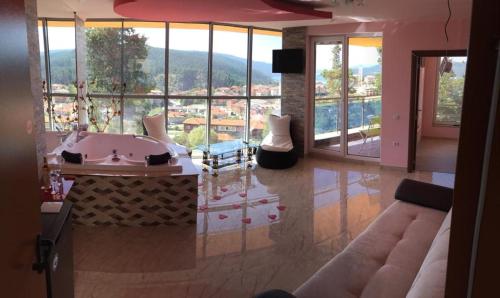 a living room with a large room with a large window at Safi in Dospat