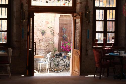 an open door to a room with a bicycle in a building at Orchis Hotel in Ayvalık