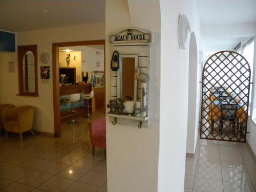 a living room with a sign on a wall at Hotel Eliani in Grado