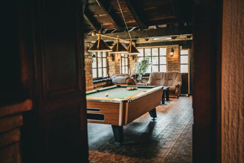 a room with a pool table and a couch at Kuća za odmor Raguž in Andrijaševci