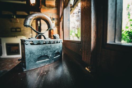 a metal object sitting on a wooden floor next to a window at Kuća za odmor Raguž in Andrijaševci