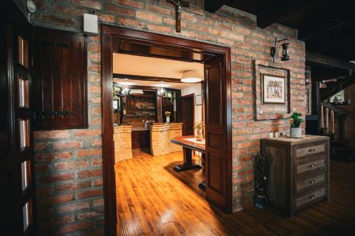 an open door to a brick room with a table at Kuća za odmor Raguž in Andrijaševci