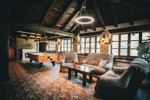 a living room with couches and a pool table at Kuća za odmor Raguž in Andrijaševci