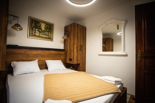 a bedroom with a large bed and a mirror at Kuća za odmor Raguž in Andrijaševci