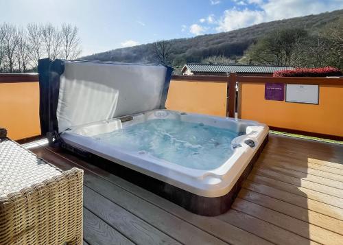 a hot tub sitting on top of a deck at Cheddar Woods Resort And Spa in Cheddar